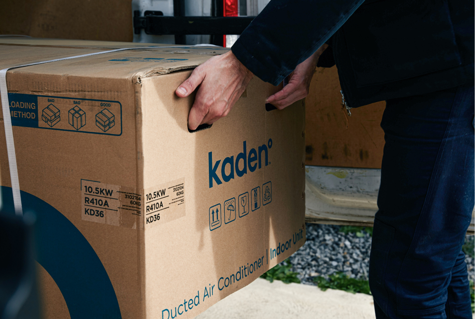 Staff member lifting Kaden box